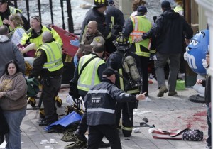 Medical workers aid injured people at the finish line of the 2013 Boston Marathon following an explosion in Boston, Monday, April 15, 2013. (AP Photo/Charles Krupa)