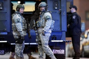  S.W.A.T. team members stand guard on the campus of Massachusetts General Hospital following an explosion at the finish line of the Boston Marathon in Boston, Monday, April 15, 2013. (AP Photo/Michael Dwyer)