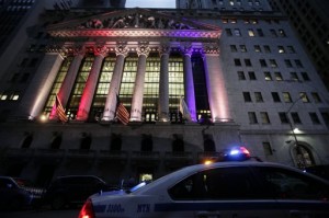 A police car patrols in front of the New York Stock Exchange, Wednesday, Oct. 31, 2012 before it reopens for trading for the first time this week following a two-day shutdown due to superstorm Sandy. Stock futures are rising ahead of the opening bell. Much of lower Manhattan and the financial district are still without electrical power. (AP Photo/Mark Lennihan)