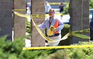 Carson City Sheriff's officials investigate the scene of a shooting in an IHOP restaurant in Carson City, Nev., on Tuesday, Sept. 6, 2011. A gunman with a rifle opened fire at a International House of Pancakes restaurantkilling three people including two uniformed National Guard members and himself, and wounding six others in a hail of gunfire during the morning breakfast hour, authorities and witnesses said. (AP Photo/Cathleen Allison)