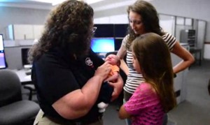 Telecommunicator Debra Sutler meets the baby boy she helped deliver just days earlier.