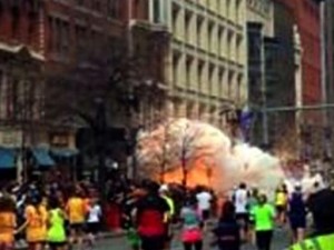 In this image from video provided by WBZ TV, spectators and runners run from what was described as twin explosions that shook the finish line of the Boston Marathon, Monday, April 15, 2013, in Boston. Two explosions shattered the euphoria of the Boston Marathon finish line on Monday, sending authorities out on the course to carry off the injured while the stragglers were rerouted away from the smoking site of the blasts. (AP Photo/WBZTV)